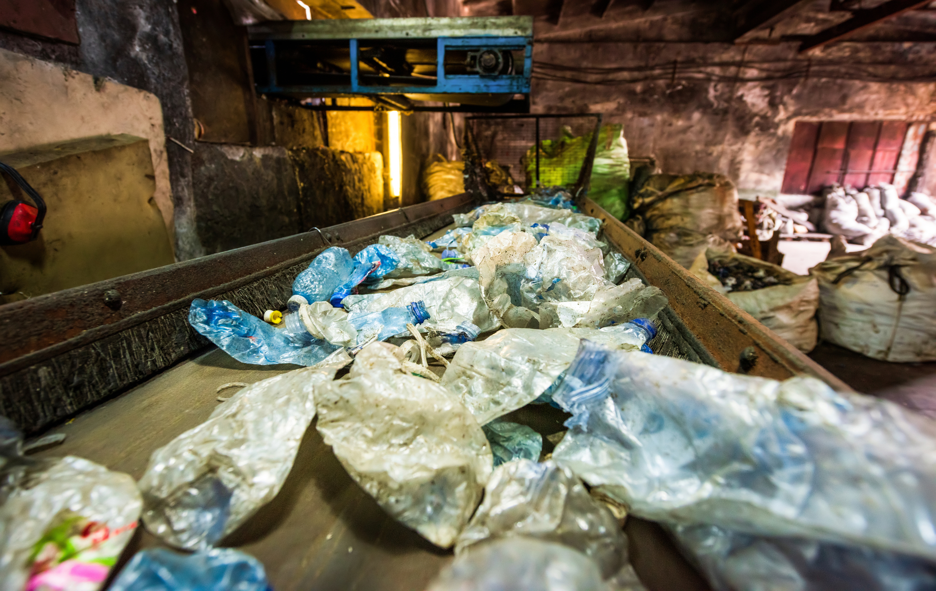 Plastic garbage on a conveyor belt at waste recycling factory